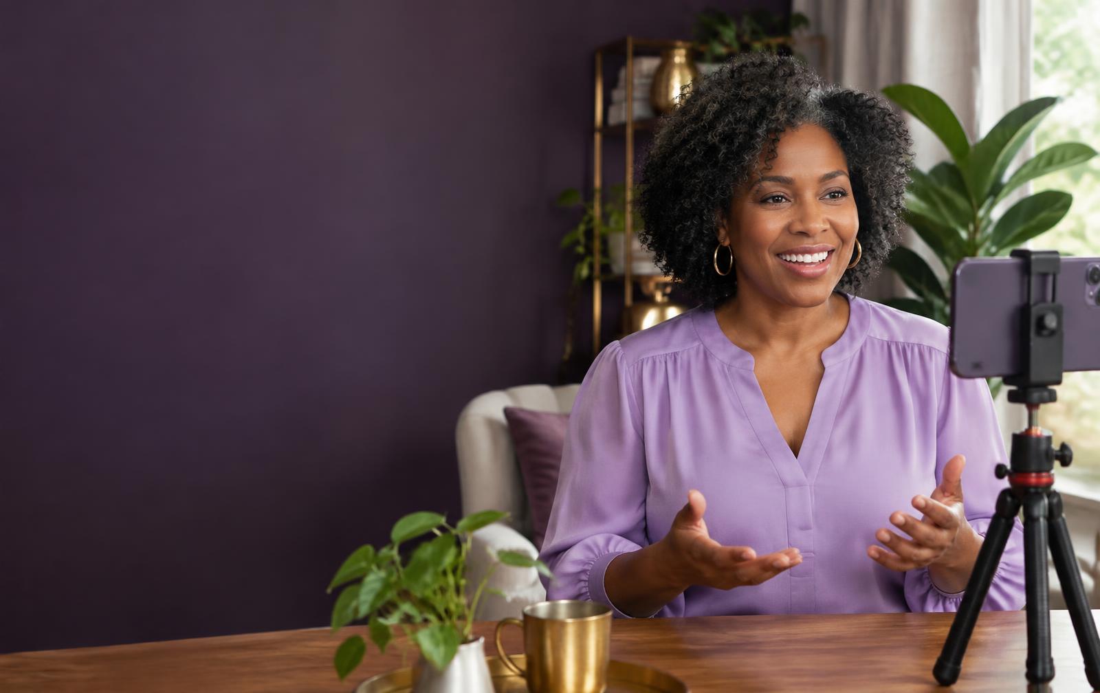 A creator recording a video with her phone at home